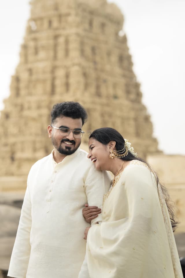 Couple leaning close together before temple architecture