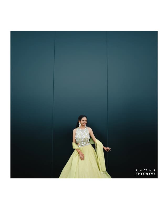 Bride posed against a deep blue backdrop in engagement attire