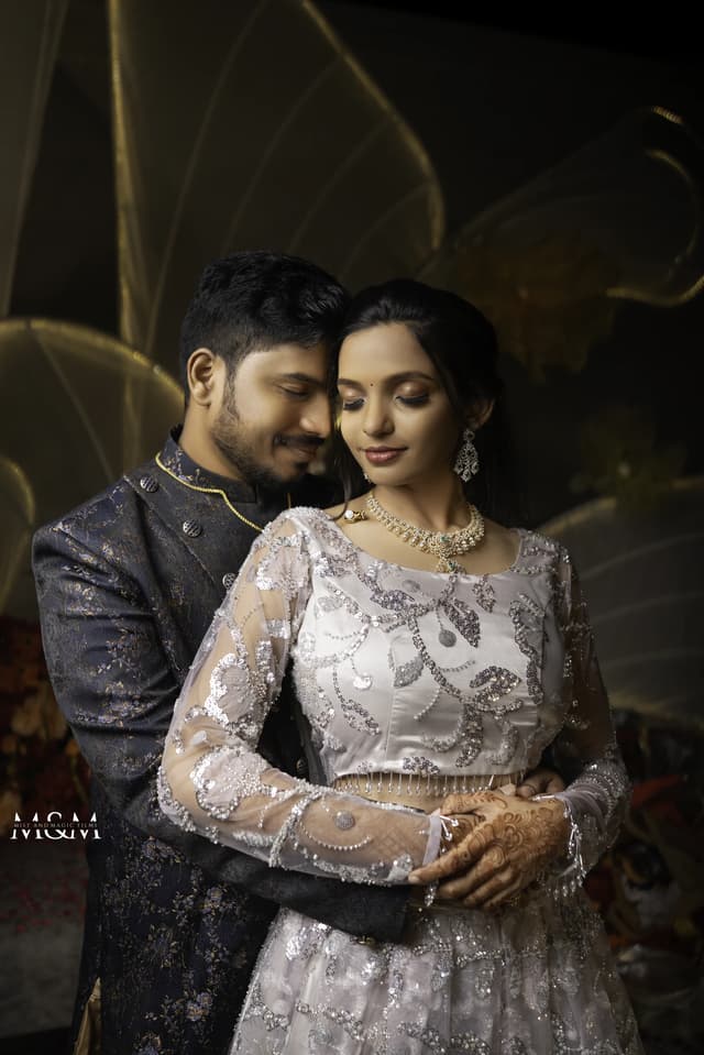 Engaged couple standing together in dramatic warm light