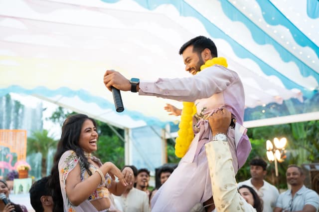 Bride smiling up at the groom during a Haldi celebration