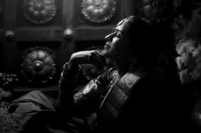 Black and white portrait of a bride reclining in soft light