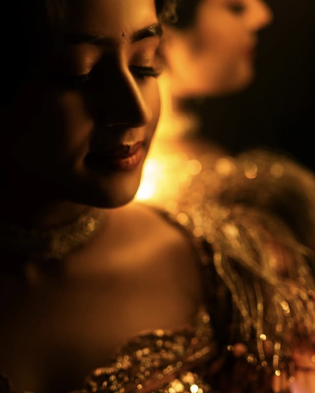 Warmly lit close portrait from a Sangeeth celebration