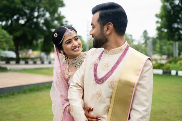 Bride and groom smiling together in a garden after the ceremony
