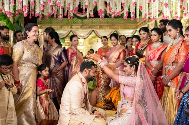 Family gathered around the couple during a wedding ceremony